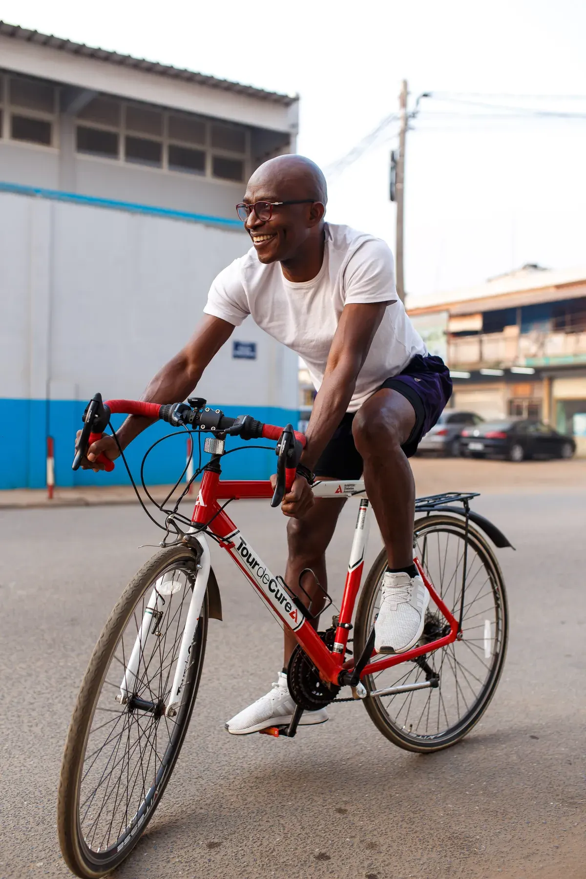 Richard Meseko cycling on a city street.
